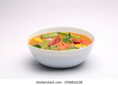 Sambar, Mixed Vegeterian Curry Arranged In A White Bowl On A White Textured Background. 