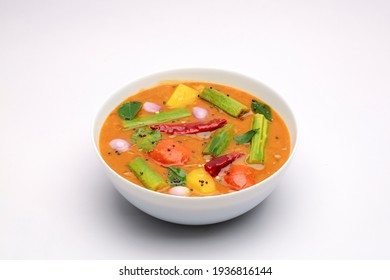 Sambar, Mixed Vegeterian Curry Arranged In A White Bowl On A White Textured Background. 