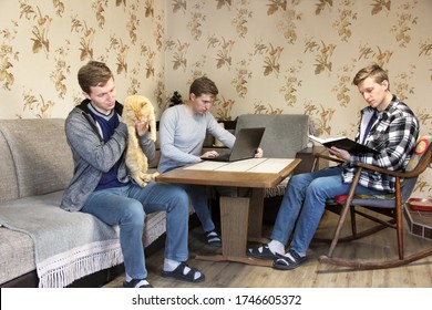 The same man. A man holds a cat in his arms. A man works at a laptop. A man in a chair reading a book.  - Powered by Shutterstock