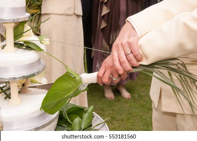 Same Sex Couple Cutting The Cake For Their Guest On Their Wedding  Reception.