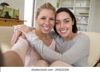 Same Sex Female Couple Taking A Selfie In Their Home