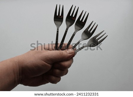 Same Three Pronged Forks In A Man Hand Isolated On White Background