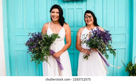 Same-sex Marriage Image Of Two Women On The Beach. Gay Girls Getting Married In A Beautiful Sunset On The Rocks Near The Beach. Real Wedding.