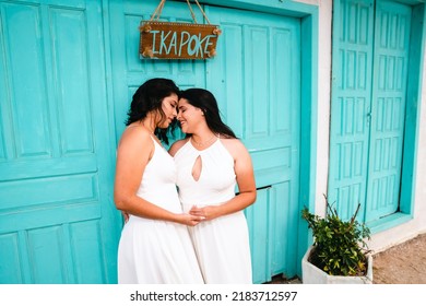 Same-sex Marriage Image Of Two Women On The Beach. Gay Girls Getting Married In A Beautiful Sunset On The Rocks Near The Beach. Real Wedding.