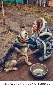 Sami Village, Sam-Syyt / Russia - August 6 2019: A Girl In Sami Clothes Strokes A Husky Dog