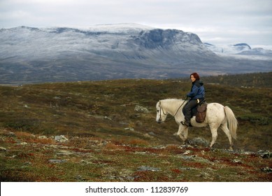 Sami Woman Rider On A Horse In The Nature, Sweden.