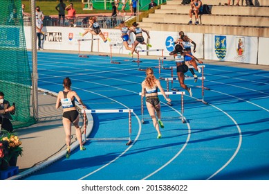 SAMORIN, SLOVAKIA, JUNE. 2. 2021: Track and Field professional race, Female athlete on the blue athletics track. 400 meters hurdles, group of athletes, wallpaper for summer olympic game in Tokyo