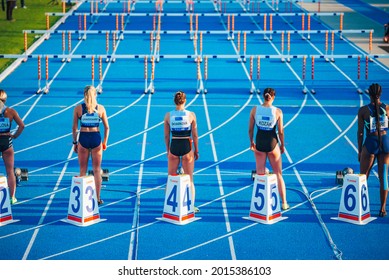 SAMORIN, SLOVAKIA, JUNE. 2. 2021: Track and Field professional race, Female athlete on the blue athletics track. 100 meters hurdles, group of athletes, wallpaper for summer olympic game in Tokyo