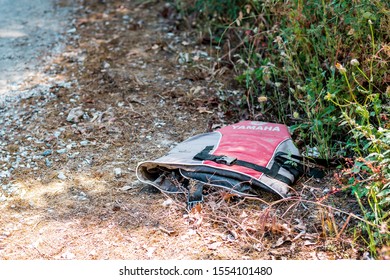 Samos, Greece – 05 24 2019 - Broken Life Jacket Of A Refugee Lying In The Bushes, Near The Beach, Mediterranean Sea