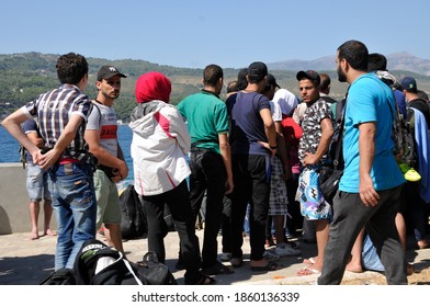 SAMOS, GREECE-August 29, 2015.Asian And African Immigrants On The Island Of Samos. (close To The Hellenic Coast Guard).Participants In The First Wave Of Mass Emigration To Europe Via Turkey And Greece