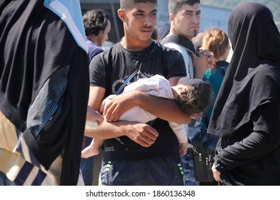 SAMOS, GREECE-August 29, 2015.Asian And African Immigrants On The Island Of Samos. (close To The Hellenic Coast Guard).Participants In The First Wave Of Mass Emigration To Europe Via Turkey And Greece