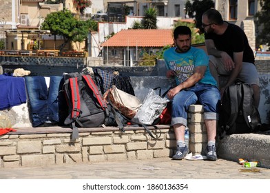 SAMOS, GREECE-August 29, 2015.Asian And African Immigrants On The Island Of Samos. (close To The Hellenic Coast Guard).Participants In The First Wave Of Mass Emigration To Europe Via Turkey And Greece