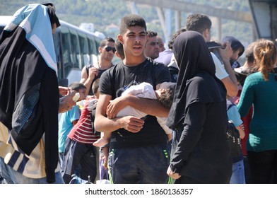 SAMOS, GREECE-August 29, 2015.Asian And African Immigrants On The Island Of Samos. (close To The Hellenic Coast Guard).Participants In The First Wave Of Mass Emigration To Europe Via Turkey And Greece