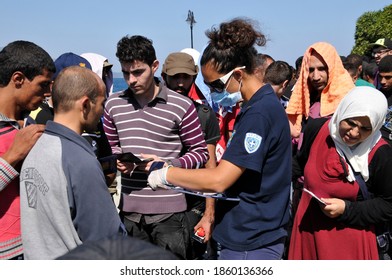 SAMOS, GREECE-August 29, 2015.Asian And African Immigrants On The Island Of Samos. (close To The Hellenic Coast Guard).Participants In The First Wave Of Mass Emigration To Europe Via Turkey And Greece