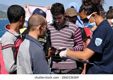 SAMOS, GREECE-August 29, 2015.Asian And African Immigrants On The Island Of Samos. (close To The Hellenic Coast Guard).Participants In The First Wave Of Mass Emigration To Europe Via Turkey And Greece