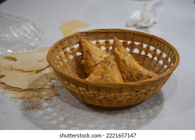 Samosa messy kitchen counter cooking Indian Pakistani Arab food spicy meat and vegetables cuisine basket bread crumbs mess spices cooking kitchen home flour salt baked brown tissue cleaning crispy - Powered by Shutterstock