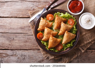 Samosa On A Plate With Sauce And Tomatoes. Horizontal View From Above, Rustic Style 