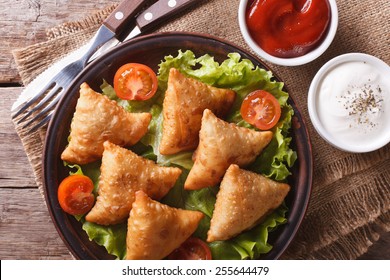 Samosa On A Plate With Sauce And Tomatoes Closeup. Horizontal View From Above, Rustic Style 