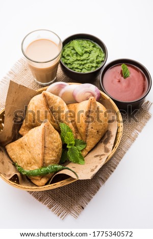 Samosa - Triangle shape fried / baked pastry with savoury filling, popular Indian Tea Time snacks, served with green chutney, tomato ketchup