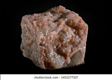 Sample of igneous rocks - granite Pegmatite isolated on a black background, macro frame
