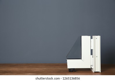 Sample of modern window profile on table against gray wall. Installation service