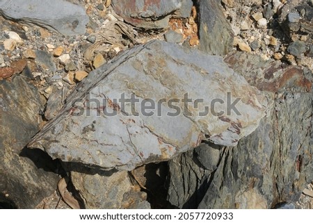 Sample of natural shale sedimentary rock. Shale is a fine-grained sedimentary rock that forms from the compaction of silt and clay-size mineral particles that we commonly call mud.