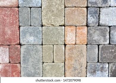 A Sample Palette Of Various Colours Of Tumbled Pavers, A Construction Material Used In The Landscape Industry To Build Patios, Walkways And Driveways Is On Display At A Garden Centre.