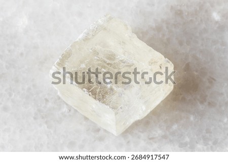 sample of rough optical calcite mineral on white marble background close up