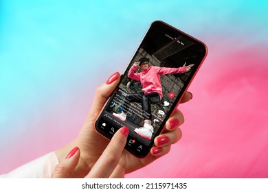 Sample social media app interface on mobile phone showing shared video content - Shutterstock ID 2115971435