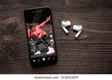 Sample social media app interface on mobile phone, concept of modern networking and sharing of video content - Shutterstock ID 2118761879