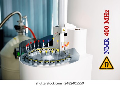 Sample tubes are placed in a tray to be analyzed by an automated NMR spectroscopy at 400 MHz. Additionally, the yellow symbol indicates a warning for high magnetic field strength in the instrument.