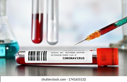 Sample vial with blood, label coronavirus test (sticker is own design, dummy barcode and data) green orange syringe above. Blurred laboratory equipment background. Covid-19 testing during outbreak