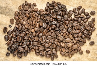 Sampler Of Coffee Beans From Different Parts Of The World - Overhead View Against Handmade Textured Paper