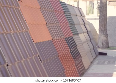 Samples Of Ceramic Roofing Tiles In A Warehouse Of A Roofing Materials Store. Modern Roof Made Of Metal. Cement Sand Tiles.