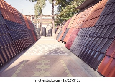 Samples Of Ceramic Roofing Tiles In A Warehouse Of A Roofing Materials Store. Modern Roof Made Of Metal. Cement Sand Tiles.