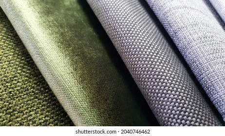 samples of curtain or drapery fabric. production of upholstered for furniture furnishing, details. macro view photo, selective focus at grey fabric texture. grey and green fabric samples swatch.