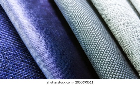 samples of curtain or drapery fabric. production of upholstered for furniture furnishing, details. macro view photo, selective focus at grey fabric texture. grey and blue velvet fabric samples swatch.