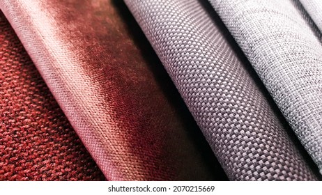 samples of curtain or drapery fabric. production of upholstered for furniture furnishing, details. macro view photo, selective focus at grey fabric texture. grey and red velvet fabric samples swatch.