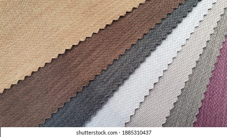 samples of fabric for interior upholstery or drapery works in earth tone color. swatch of zigzag pattern fabric.