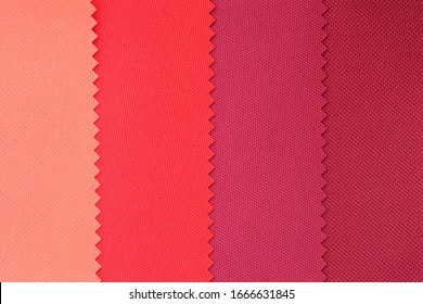 Samples of fabrics in pastel colors. red and pink piece of fabric with texture. Lightweight fabric made of synthetic fibres (nylon or polyester) of a certain structure with a special coating.