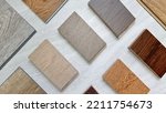 samples of interior wooden flooring material consists oak, walnut, ash, douglasfir engineering (or laminate) flooring, ash and oak vinyl tile. top view of selected material board for selection.