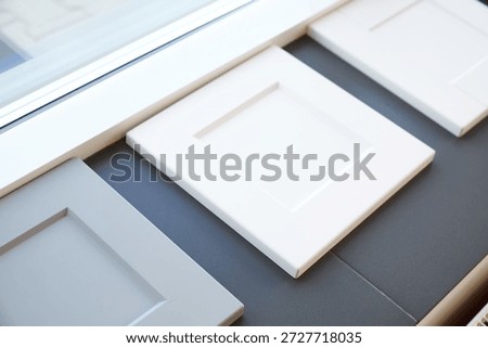 Samples of kitchen cabinet fronts in different colors for choosing an interior design.