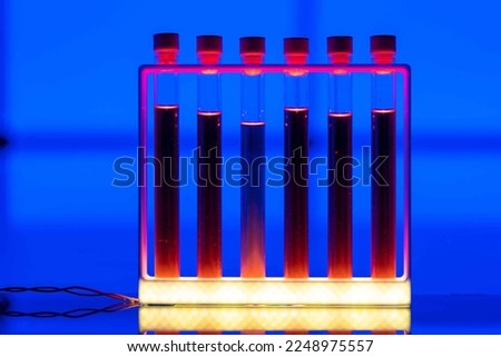 samples of radioactive liquid in test tubes in a nuclear physics laboratory