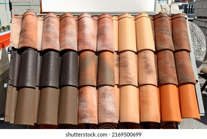 Samples Of Terracotta Roof Tiles On Show By The Building Material Store. Background And Texture.