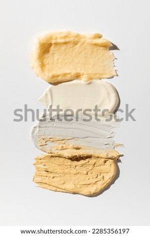 Samples and textures of various cosmetics for skin and hair care. Swatches. Skin care.