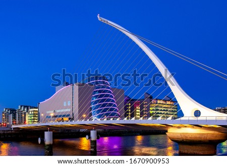 The Samuel Beckett Bridge over the River Liffey in Dublin, Ireland with the National Convention Centre in the background.