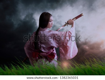 samurai in kimono holding katana sword and looking away