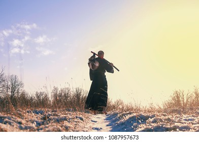 A Samurai Monk Walking Away In The Snow