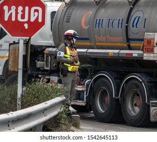 SAMUT PRAKAN, THAILAND, APR 27 2019, A Traffic Cop Directing Traffic On The Road. Policeman Control Traffic At Crossroads In City Street. 