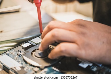 Samut Prakan, Thailand - February, 2019: Dell laptop repair technician removing components from the laptop assembly to perform the required maintenance